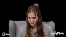 a woman is sitting in a chair with the word jots above her head