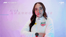a woman wearing a tag heuer jacket is smiling for the camera