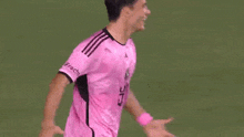two soccer players are hugging each other on the field .