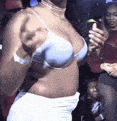 a woman in a blue bra is taking a picture of herself with her phone