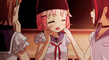 a girl with pink hair is touching another girl 's cheek