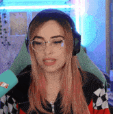 a woman wearing glasses and headphones has a sticker on her shirt that says ' i love you '