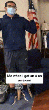 a man wearing a mask is standing in front of an american flag