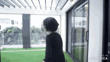 a woman is standing in front of a sliding glass door made in animotica