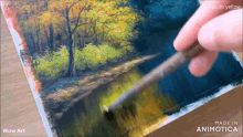 a person is painting a landscape with a brush and the words wow art above it