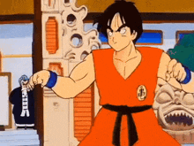 a cartoon character in a red karate uniform is holding a sword in front of a statue .