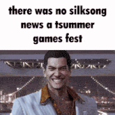 a man in a suit smiles in front of a sign that says there was no silksong news a tsummer games fest