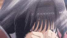 a close up of a girl covering her eyes with her hand