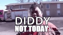 a man is standing in front of a building with the words diddy not today written on it .
