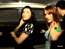 a couple of women standing next to each other with rbd.gif in the lower right corner