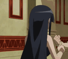 a girl with long black hair is standing in front of a wall with a picture frame and the word artz on it