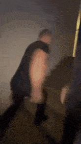 a blurry picture of a person standing on a couch