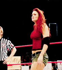 a woman stands in a ring with a sign that says lovely