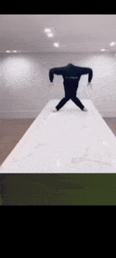 a person is standing on a white table with their legs crossed .
