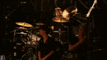 a man playing drums in front of a drum set that says tama on it