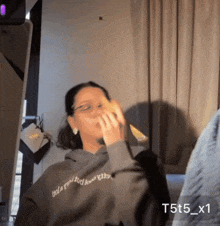 a person wearing a hoodie that says t5t5_x1