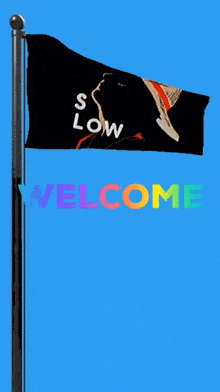 a flag that says s low welcome is flying in the wind