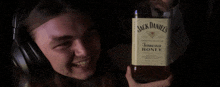 a man holds a bottle of jack daniels tennessee honey
