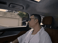 a man wearing sunglasses is sitting in a car