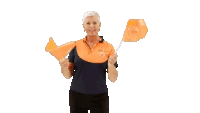 a woman in an orange and blue shirt holds two orange flags in her hands