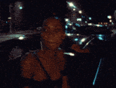 a woman in a black dress is standing in front of a car