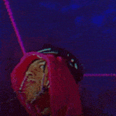 a man in a pink hat is making a funny face with his tongue out
