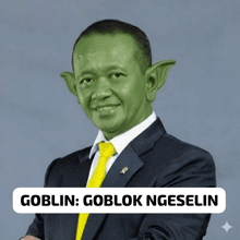 a man in a suit and tie has his face painted green and the caption goblin goblok ngeseling