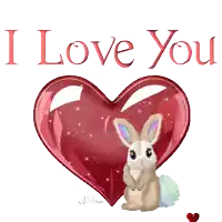 a bunny is sitting in front of a red heart that says i love you
