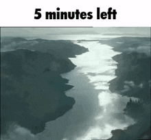 an aerial view of a river surrounded by mountains with the words 5 minutes left on the bottom .