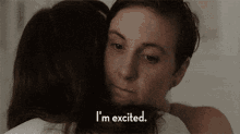 a woman hugging another woman with the words i 'm excited