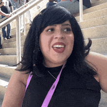 a woman with a lanyard around her neck that says ' women 's health ' on it