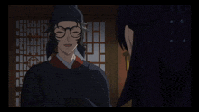 a man with glasses and a black hat is smiling