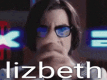a close up of a person wearing glasses with the name lizbeth on the bottom