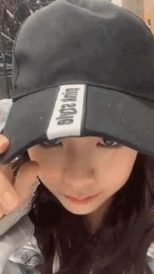 a woman wearing a black hat with the word king on the side