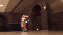 a robot is coming out of a doorway with a box that says ' ambulance ' on it