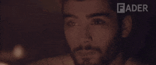 a close up of a man 's face with the word fader in the background