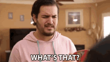 a man in a pink hoodie is asking what 's that