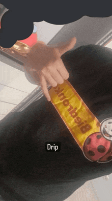 a person wearing a black shirt that says drip