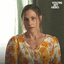 a woman in a floral shirt has the words you 're my hero on the bottom right