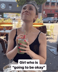 a woman is drinking a green drink with a straw and says " girl who is " going to be okay "