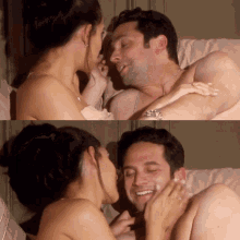 a woman kisses a man on the cheek in bed