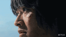 a close up of a man 's face with the word netflix on the bottom right