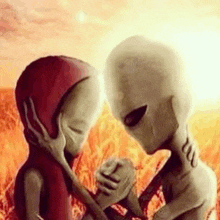 two aliens are standing next to each other in a field holding hands .