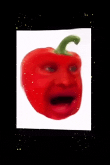 a red pepper with a green stem looks like a person 's face