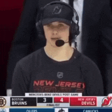 a man wearing headphones and a new jersey devils jersey