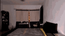 a blurry picture of a bedroom with a bed and a window