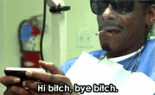 snoop dogg is smoking a cigarette while holding a cell phone and saying hi bitch bye bitch .