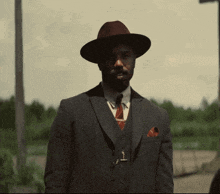 a man in a suit and hat with the words nah we good written below him