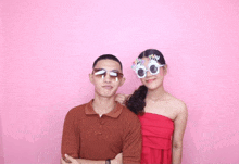 a man and a woman standing next to each other wearing sunglasses that say happy birthday