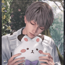 a man holding a stuffed animal with the words " spring and flowers " on the bottom right